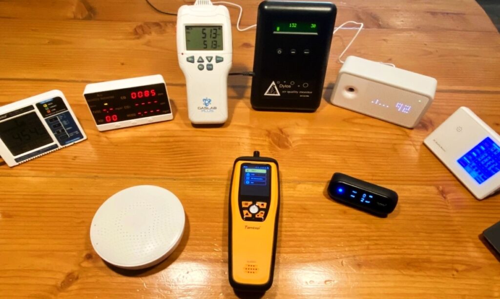 What We Picked, and How We Tested Indoor Air Quality Monitors here different indoor air quality monitors are laying on table 