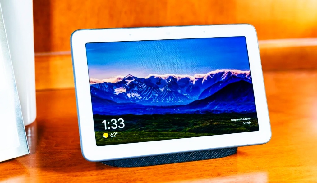 there are a Google Nest Hub device thats on table and device showing its display with image of blue rocks